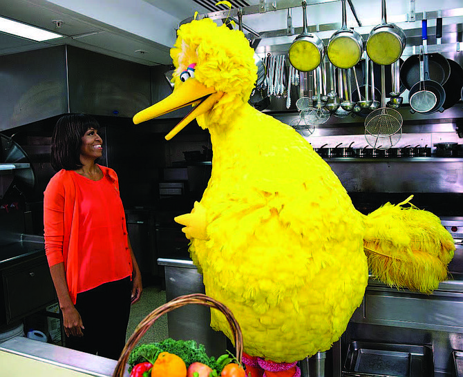 Michelle Obama participates in a Let’s Move! and Sesame Street public service announcement taping with Big Bird in the White House Kitchen, 2013.