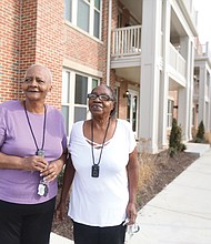 Nancy Ward, left, and her friend and neighbor, Lorraine Cavell, stand in front of their new apartment building in the Armstrong Renaissance complex that has replaced Armstrong High School in the 1600 block of North 31st St.