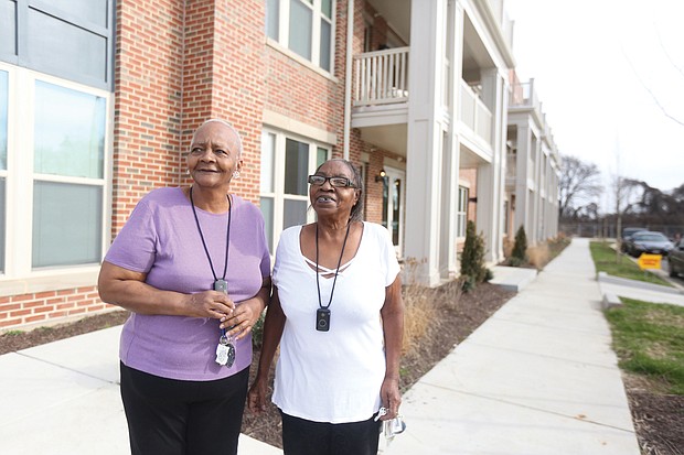 Nancy Ward, left, and her friend and neighbor, Lorraine Cavell, stand in front of their new apartment building in the Armstrong Renaissance complex that has replaced Armstrong High School in the 1600 block of North 31st St.