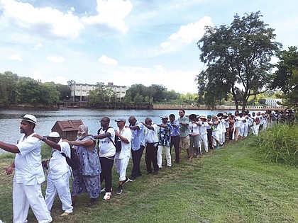 Participants at the Black Lives Global Summit in August march in a line along the Richmond Slave Trail beside the James River in remembrance of the thousands of enslaved people led in coffles from the Old Manchester docks to markets in Shockoe Bottom before the end of the Civil War. Richmond was one of the largest markets in the South for the sale of enslaved people. The summit focused on emotional and psychological healing from the lingering impact of slavery.
