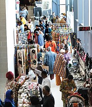 Hundreds of people peruse the various wares in the African Market at the 29th Annual Capital City Kwanzaa Festival held last Saturday at Martin Luther King Jr. Middle School. The event featured speaker Dr. Runoko Rashidi, a noted anthropologist and historian, who addressed the group via Skype, as well as numerous activities for families and entertainers. This year’s theme: “Ascension,” marking the crossing from the 400th year of the arrival in Virginia of the first enslaved Africans to the hope for the future.