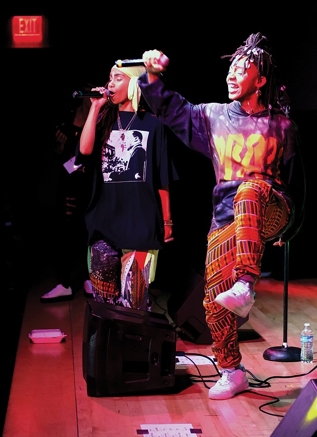 Niambi Sala, left, and Thandiwe of the hip-hop/soul duo OSHUN inspire the crowd with song. The annual celebra- tion of African-American culture ran Dec. 26 through Jan. 1, honoring seven principles — unity, self-determination, collective work and responsibility, cooperative economics, purpose, creativity and faith.