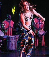 Imani Bell of the Elegba Folklore Society, which puts on the festival, performs with African drummers.