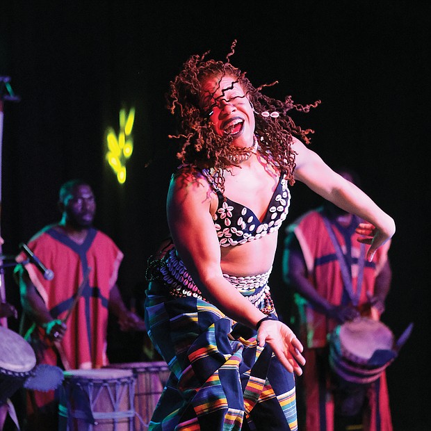 Imani Bell of the Elegba Folklore Society, which puts on the festival, performs with African drummers.