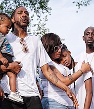 Her family members grieve at a vigil in early June at the South Side park. They are from left, her father, Mark Whitfield Sr., who is holding young Mark Jr.; mother Ciara Dickson; sister Samaya Dickson; and uncle Dion Tuell.