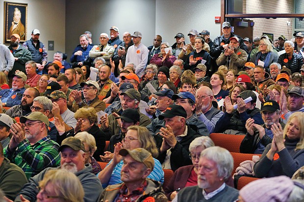 Spectators break into applause as the Buckingham County Board of Supervisors vote unanimously on Dec. 9 to approve a resolution making the county a Second Amendment Sanctuary as a safe space for gun owners who reject gun control measures.