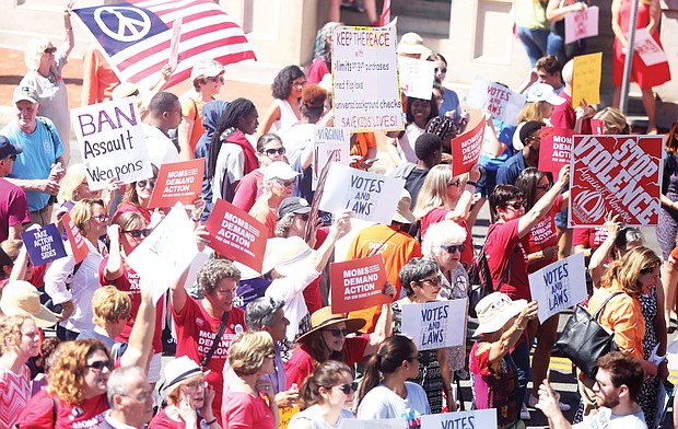Supporters of tougher gun laws in Virginia wave signs and banners during a rally in July at the Bank Street entrance to the State Capitol before a special General Assembly session called by Gov. Ralph S. Northam to deal with gun violence in the wake of the shooting death of 9-year-old Markiya Dickson in Richmond and the mass shooting in Virginia Beach that left 12 dead. The Republican-led General Assembly adjourned, however, without considering the governor’s package of bills.