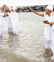 Queen mothers from the Institute of Whole Life Healing in Kentucky anoint people during a sunrise cleansing and healing ceremony at Buckroe Beach in Hampton as part of the August events commemorating the 400th anniversary of the first Africans arriving via slave ships in English North America.