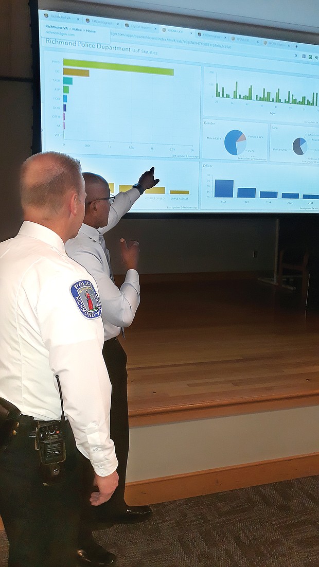 Richmond Police Chief Will Smith listens as technology manager Pierre Redding describes the new records management system and what it will offer during a recent event for the media and others who will use the data.