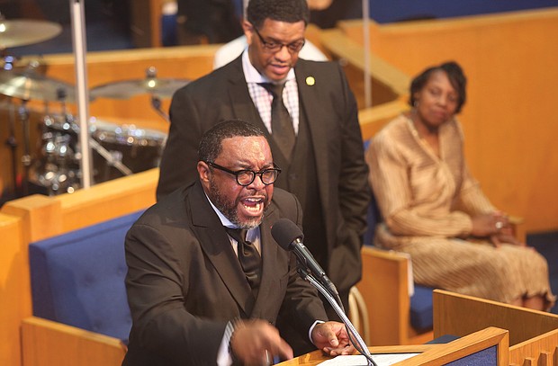 The Rev. Darran Brandon, pastor-elect of First Calvary Baptist Church of Norfolk, challenges his audience of more than 300 people to remain positive and trust that God will enable them to weather current challenges in his address Jan. 1 at the annual Emancipation Proclamation Day Worship Celebration as the Rev. Melvin Shearin of Great Hope Baptist Church stands in support.
