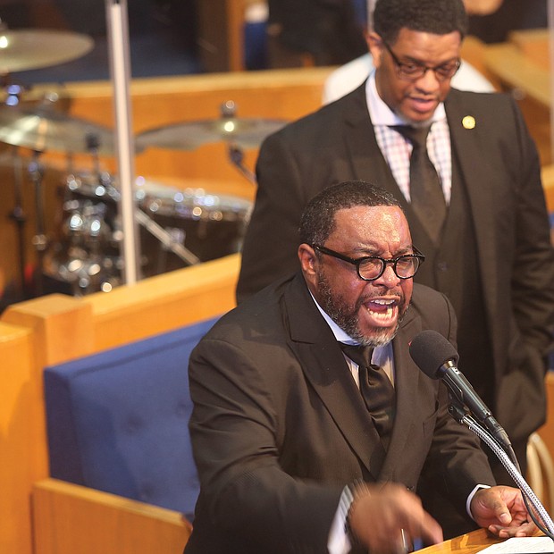 The Rev. Darran Brandon, pastor-elect of First Calvary Baptist Church of Norfolk, challenges his audience of more than 300 people to remain positive and trust that God will enable them to weather current challenges in his address Jan. 1 at the annual Emancipation Proclamation Day Worship Celebration as the Rev. Melvin Shearin of Great Hope Baptist Church stands in support.