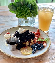ricotta pancakes topped with blueberries and strawberries at The Dunlavy