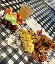 fried chicken, eggs, potatoes, bacon, and fruit from The Breakfast Klub