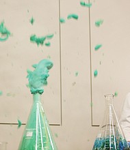 Miss America 2020 Camille Schrier stands back as her “elephant toothpaste” experiment erupts as planned with blue and green foam during a demonstration Wednesday for Carver Elementary School students at the Science Museum of Virginia.