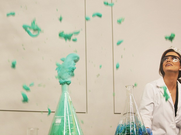 Miss America 2020 Camille Schrier stands back as her “elephant toothpaste” experiment erupts as planned with blue and green foam during a demonstration Wednesday for Carver Elementary School students at the Science Museum of Virginia.