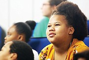 Fourth-grader Aneja Hutcherason listens closely as Ms. Schrier, a graduate student at the VCU School of Pharmacy, talks about science, taking risks and success.