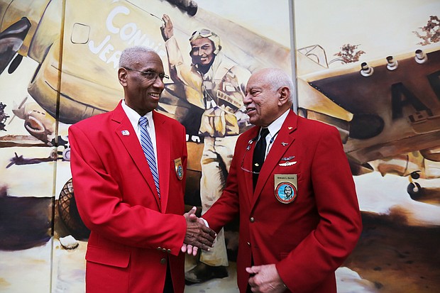Rep. A. Donald McEachin of Richmond, left, is congratulated by Howard L. Baugh of Portsmouth after the con- gressman was made an honorary Tuskegee Airman during a ceremony last Saturday by the Howard Baugh Chapter of Tuskegee Airmen Inc. in Petersburg. Mr. Baugh is the oldest son of the late Lt. Col. Howard Baugh of Petersburg who was one of the famed airmen of the 99th Pursuit Squadron and the 332nd Fighter Group that escorted bombers on combat missions over Europe during World War II. Lt. Col. Baugh was honored during his lifetime with numerous commendations, including the Distinguished Flying Cross, the Air Medal with three Oak Leaf Clusters and the U.S. Air Force Commendation Medal, along with the French Legion of Honor Award bestowed by the French government. The ceremony was held at the Richmond Executive Airport in Chesterfield County. The Petersburg group is one of 56 Tuskegee Airmen chapters in the United States dedicated to honoring the accomplishments and preserving the legacy of the airmen who trained at the Tuskegee
Army Air Field in Alabama.