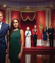 Figures of Britain’s Prince Harry and his wife, Meghan Markle, are now situated apart from their original positions next to Queen Elizabeth II, rear from left, Prince Philip and Kate, the Duchess of Cambridge, and Prince William at Madame Tussauds Wax Museum in London following the couple’s announcement earlier this month that they are stepping down as working royals.