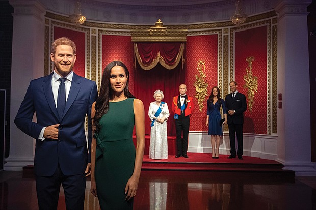 Figures of Britain’s Prince Harry and his wife, Meghan Markle, are now situated apart from their original positions next to Queen Elizabeth II, rear from left, Prince Philip and Kate, the Duchess of Cambridge, and Prince William at Madame Tussauds Wax Museum in London following the couple’s announcement earlier this month that they are stepping down as working royals.