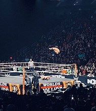 Finn Balor executing his “Coup De Grace” double Stomp finisher on his opponent, Ilja Dragunov