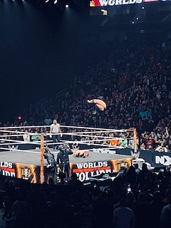 Finn Balor executing his “Coup De Grace” double Stomp finisher on his opponent, Ilja Dragunov