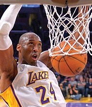 Kobe Bryant jumps almost as high as the rim to dunk the ball during a game against the Indiana Pacers in Los Angeles on Jan. 4, 2015.