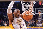 Kobe Bryant jumps almost as high as the rim to dunk the ball during a game against the Indiana Pacers in Los Angeles on Jan. 4, 2015.