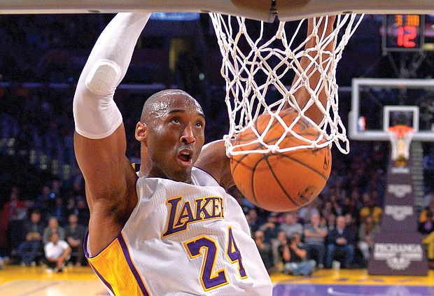 Kobe Bryant jumps almost as high as the rim to dunk the ball during a game against the Indiana Pacers in Los Angeles on Jan. 4, 2015.