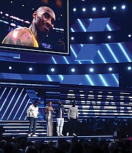 Grammy host Alicia Keys, second from left, and members of Boyz II Men, from left, Nathan Morris, Wanya Morris and Shawn Stockman, sing “It’s So Hard to Say Goodbye to Yesterday” during a tribute to late basketball star Kobe Bryant to open the award’s show Sunday night in Los Angeles. Below, Lizzo needs both hands to hold her awards won for best pop solo performance for “Truth Hurts;” best urban contemporary album for “Cuz I Love You;” and best traditional R&B performance for “Jerome.”