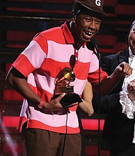 Tyler, the Creator accept the Grammy Award for best rap album for “Igor” during the ceremony televised from the Staples Center.