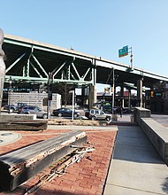 Vandals damaged the two wooden benches Street Station. The benches and statue wereat the Richmond Slavery Reconciliation Statue in Shockoe Bottom. The damage was discovered on Jan. 20, the Martin Luther King Jr. Holiday, following a gun rights demonstration that drew thousands of people to Capitol Square nearby. A Free Press photographer later spotted the problem at the 13-year-old statue site at 15th and Main streets near Main Street Station. The benches and statue were unveiled on March 30, 2007, as part of an international reconciliation project. Identical statues stand in Liverpool, England, a home port for slave ships, and in Contonou, Benin, the port from which many enslaved people were transported to Virginia before the importation of enslaved people was banned in the United States in 1807.