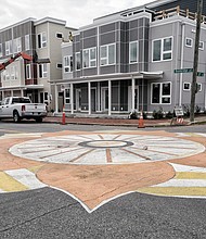 The intersection of 12th and Bainbridge streets in South Side is artistically decorated with a colorful splash, telltale of the boom the Manchester sector of the city is undergoing in construction of new homes and multistory apartments. Seen here is Manchester Green, a 78-unit complex of townhouses, duplexes and apartments that has been underway for two years in the block bounded by 12th, 13th, Bainbridge and Porter streets. The 2-acre, low-rise development is one of the latest from Urban Development Associates led by Robin Miller and Dan Gecker and is a larger version of the
eight townhomes they built several years ago one block north between Porter and Perry streets.