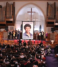 People applaud and take photos during the unveiling ceremony Jan. 30 for the new U.S. Postal Service Black Heritage series stamp honoring the late journalist Gwen Ifill. The ceremony took place at the church she was a member of, Metropolitan African Methodist Episcopal Church in Washington.