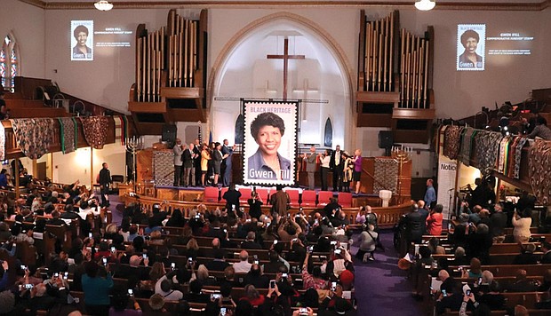 People applaud and take photos during the unveiling ceremony Jan. 30 for the new U.S. Postal Service Black Heritage series stamp honoring the late journalist Gwen Ifill. The ceremony took place at the church she was a member of, Metropolitan African Methodist Episcopal Church in Washington.