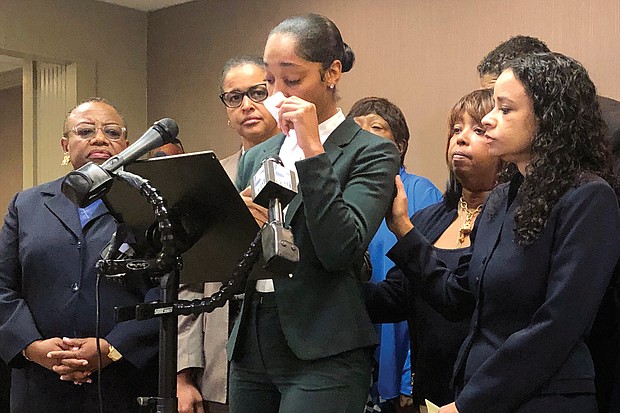 Jazmyne Childs, center, cries during a news conference in Raleigh, N.C., in September as she describes the sexual harassment she said she endured while working for the North Carolina State Conference NAACP. She filed a $15 million lawsuit Monday against the national NAACP, which she alleges condoned the behavior.