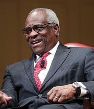 U.S. Supreme Court Justice Clarence Thomas smiles during an event in February 2018 at the Library of Congress.