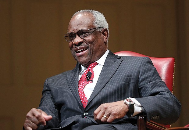 U.S. Supreme Court Justice Clarence Thomas smiles during an event in February 2018 at the Library of Congress.