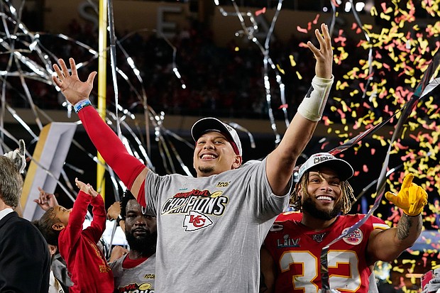 Kansas City Chiefs quarterback Patrick Mahomes, center, and safety Tyrann Mathieu, right, celebrate the team’s 31-20 victory over the San Francisco 49ers in last Sunday’s Super Bowl LIV.