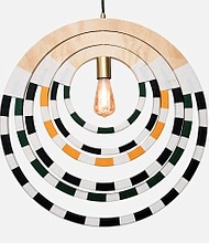 The Ndebele Necklace Pendant Lighting is handmade in South Africa and inspired by classic jewelry from the region. Wooden rings compose the pendant in a shape reminiscent of a necklace held together by woven threads. MSRP: $625