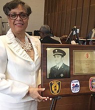 Raynell Reid shows off a tribute plaque to her late uncle, Richmond Fire Capt. Harvey S. Hicks II, during a ceremony last Sunday at Mosby Memorial Baptist Church. The ceremony marked the 70th anniversary of the hiring of the first 10 black firefighters in Richmond and Virginia. Capt. Hicks died June 4, 1963, attempting the daring rescue of a city resident who was trapped in a 23-foot-deep pit. The church joined with Engine Company No. 9 and Associates, a nonprofit group that works to call attention to the city’s pioneering black firefighters and police officers, on the Black History Month program. Richmond hired the first black police officers in 1946 and the first black firefighters in 1950. At the time of his death, Capt. Hicks also was studying for the ministry and was to preach his trial sermon a few days later. As part of Sunday’s commemoration, Dr. Price L. Davis, pastor of the church at 2901 Mechanicsville Turnpike, preached the sermon that the firefighter had written.