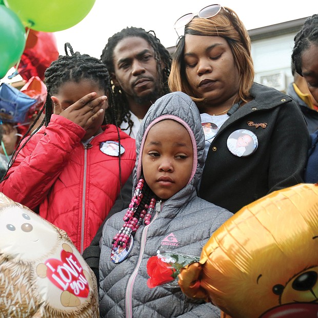Shamar's grieving family joins mourners at the vigil — parents Sharmar Hill Sr. and Shaniqua Allen, center rear; and sisters, from left, Len’Naveya Smith, 10; Len’Niesha Smith, 7; and Ni’Aveya Allen, 14. The youngster’s death has touched the community, with hundreds of people, including Gov. Ralph S. Northam, Mayor Levar M. Stoney and Richmond Police Chief Will Smith, attending his funeral Monday at New Life Deliverance Tabernacle on Decatur Street. No arrest has been made yet in the youngster’s death.