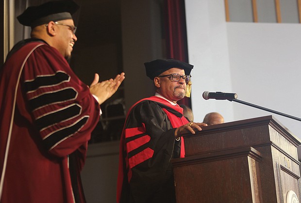 Delegate Luke e. Torian of Prince William County, right, receives a standing ovation following his keynote address last Friday at Virginia union university’s 155th Anniversary Founders Day Convocation. Joining in the applause is Vuu President Hakim J. Lucas.