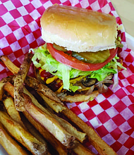 The Junkie Burger, which has vegan American cheese, smashed avocado, sautéed mushrooms and grilled onions, crispy onion strips, lettuce, pickles, tomato, with a garlic and onion aoli, is one of Plant Based Junkie Owner Bobbie Beaugard’s favorite menu items. Photo Credit: Bobbie Beaugard.