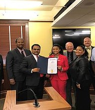 Fort Bend County Judge K.P George along with members of Commissioner’s Court and Sienna Sauce founder Tyla-Simone Crayton and family.