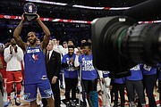 Kawhi Leonard of the Los Angeles Clippers holds up the Kobe Bryant MVP Award he won for his spectacular effort on Team LeBron in the All-Star Game.