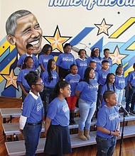 The Barack Obama Celebration Choir sings an original song, “O,” about the former president during last Friday’s dedication ceremony. A mural by Richmond artist Hamilton Glass is behind them.