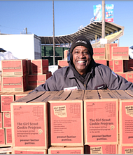 Duane Brannon shows off the boxes of Girl Scout cookies he and other volunteers from Dunmar Moving helped unload last Saturday at The Diamond on behalf of the area Girl Scouts of the Commonwealth of Virginia. The ballpark in North Side was one of three drop-off spots for the 1 million boxes of Thin Mints and other Girl Scout cookie favorites that are being delivered and sold through the end of March. Youth members and supportive adults came to those points to pick up the cookies for delivery to customers.