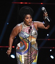 Above, Lizzo accepts her top honor for entertainer of the year at the 51st Annual NAACP Image Awards last Saturday in Pasadena, Calif.