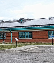 On a clear or cloudy day, several Richmond schools are generating energy to help power their facility. Here, solar panels on the roof of Lucille M. Brown Middle School on Jahnke Road in South Side are the latest effort by Richmond Public Schools to “Go Green” and cut energy costs. Richmond Public Schools Superintendent Jason Kamras, Gov. Ralph S. Northam and other officials held a news conference last Friday at the school to announce that the last of 10 city schools now have solar panels. The panels will produce enough electricity to cover about 24 percent of the schools’ electrical needs. The $2.9 million project, which also includes an energy monitoring system, was completed during the summer and was paid for by a grant from RVA Solar Fund, part of the Community Foundation for a Greater Richmond, and were developed by Secure Futures Solar, a clean energy company. The panels will save RPS approximately $2 million in utility costs over the next 20 years, or about $100,000 annually, officials said. Officials said it is the largest solar energy system at a K-12 school division in Virginia to date. The other city schools with solar panels are Huguenot High School, Martin Luther King Jr. Middle School and Oak Grove, Miles J. Jones, Linwood Holton, Blackwell, Fisher, Broad Rock and G.H. Reid elementary schools.
