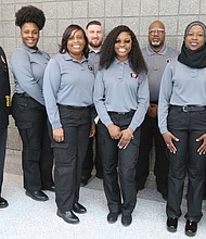 Seven new graduates of the Richmond Department of Emergency Communications’ 33rd Basic Dispatch Academy celebrate after a ceremony last Friday at the Richmond Police Training Academy. The new graduates are, from left, Stephanie Z. Franklin, Kyna Meadows, Joseph Kearns, Zakiya St. Dic, Woody Winborn, Safiyyah Muslima Bint Abdul Malik and Justin Fleming. They are flanked at left by Stephen M. Willoughby, director of the Department of Emergency Communications, and at right by Ortoria Hymons, the department’s acting training supervisor. The graduates began their training on Jan. 6 with classroom sessions on dispatch procedures, public safety terminology, handling difficult callers and active shooter situations and fires, and various policies and procedures. They practiced answering 911 emergency calls, rode along with Richmond Police officers and passed several tests to make it to graduation. Now they must complete hundreds of hours of on-the-job training before they can work independently taking 911 calls and dispatching help.